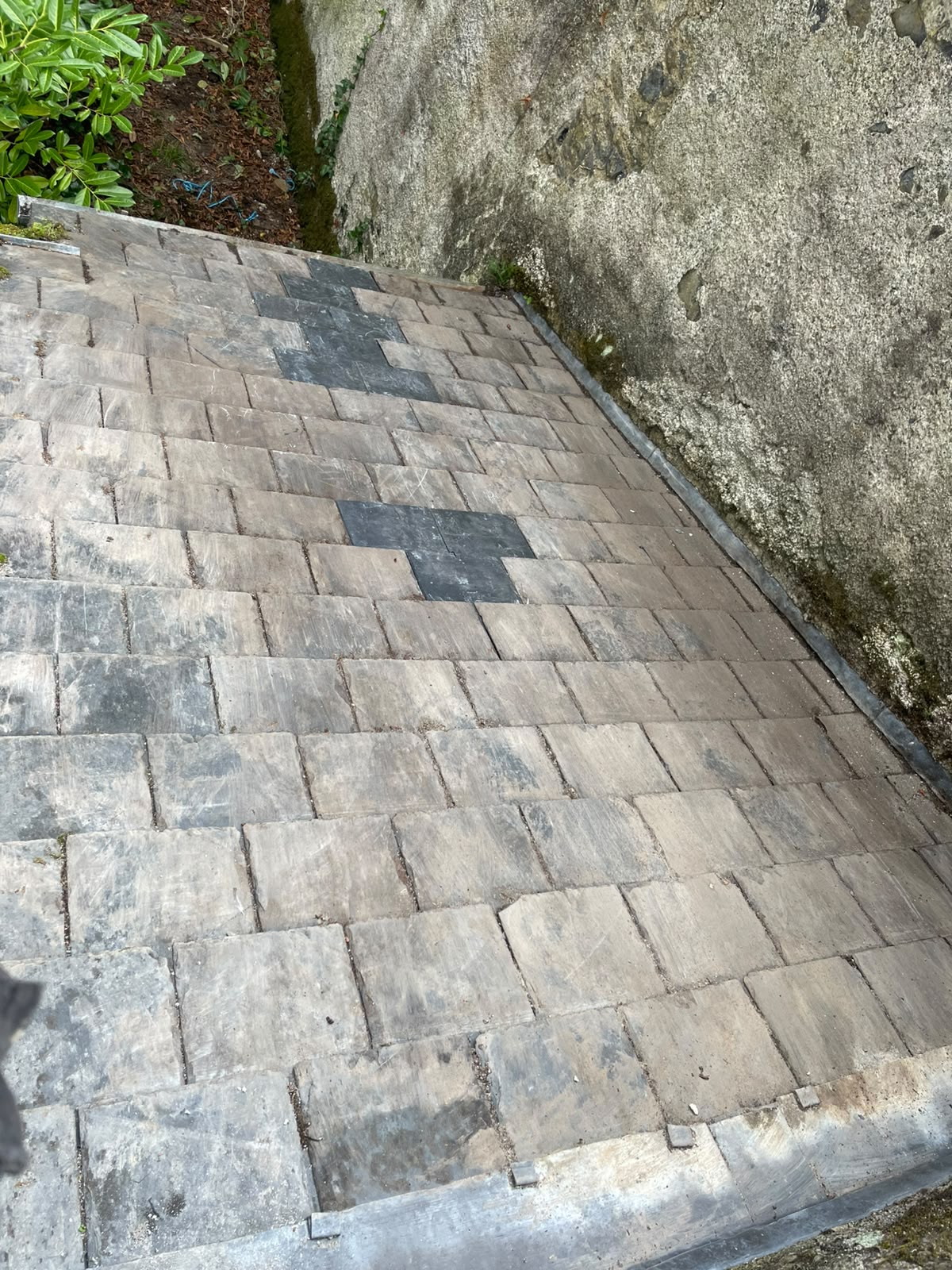 Round stone tower with completed slate roof by Stonevale Construction