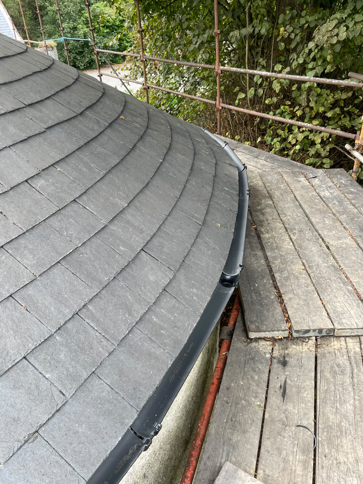 Curved slate roof edge and new guttering by Stonevale Construction