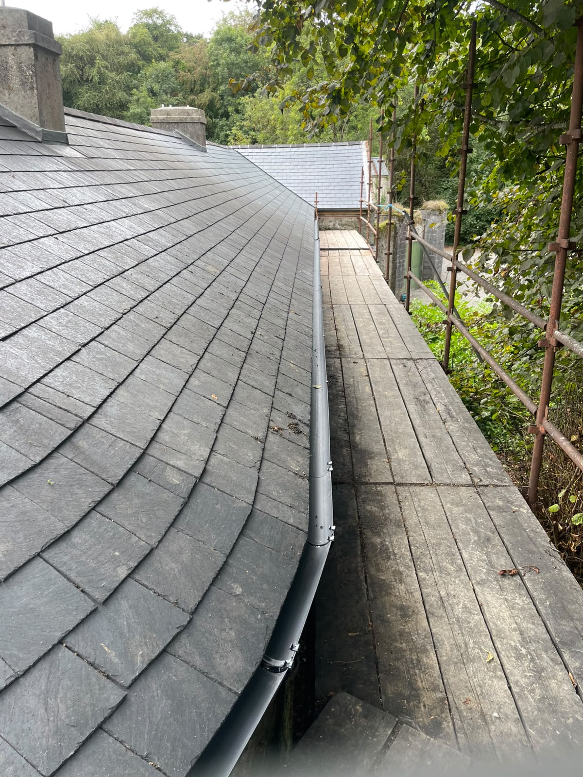 Slate roof and downpipe detail by Stonevale Construction