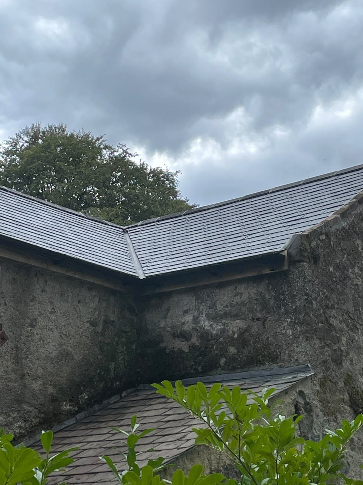 New slate roofing against stone gable wall by Stonevale Construction