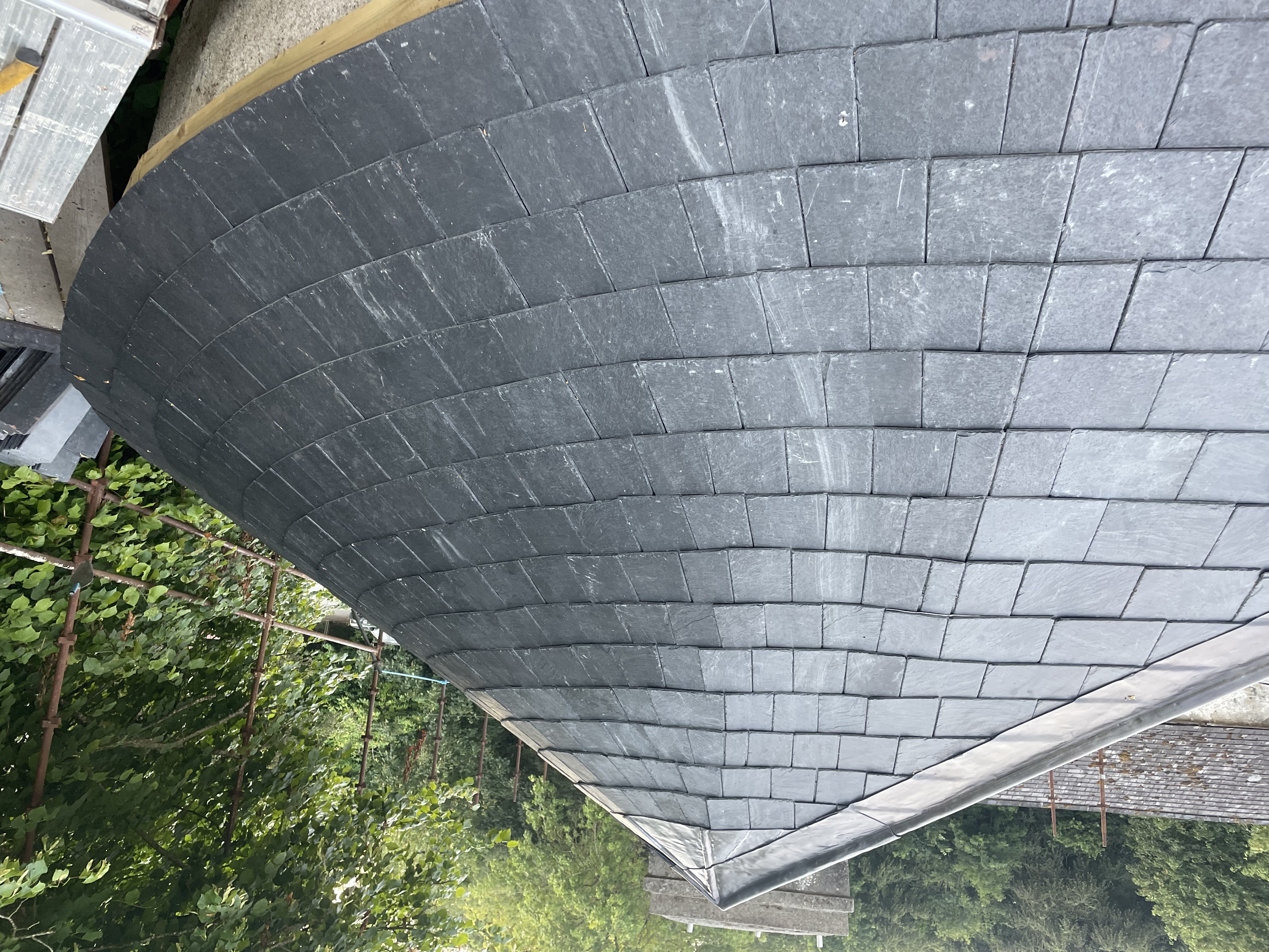 Conical slate roof by Stonevale Construction